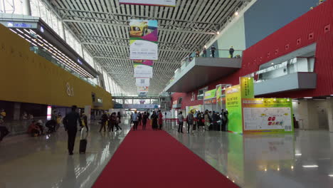Walking-inside-almost-empty-hall-of-Canton-Fair-exhibition-complex-with-a-few-visitors-during-COVID-19-pandemic