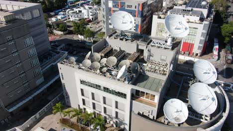 Cluster-of-Satellite-broadcast-Dishes-on-Asia-Pacific-Telecommunications-building-in-Hong-Kong,-Aerial-view