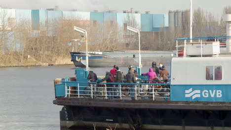 People-on-deck-of-Amsterdam-ferry-waiting-for-boat-to-cross-river