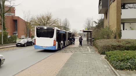 Wide-shot-of-population-entering-and-exit-german-public-bus-during-bright-day