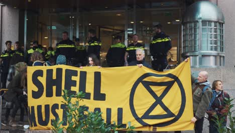 Group-Of-Activists-Displaying-A-Large-Banner-Declaring-"Shell-Must-Fall