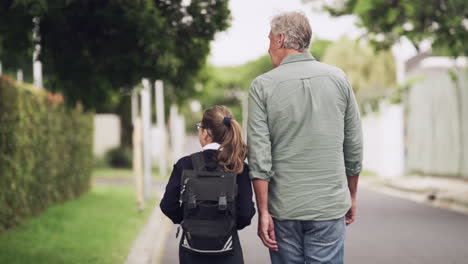 a-senior-man-walking-his-granddaughter-home