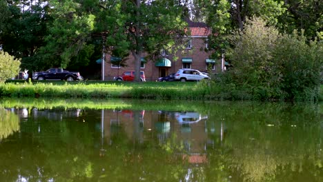 Residential-street-view-reflection-on-pond-surface