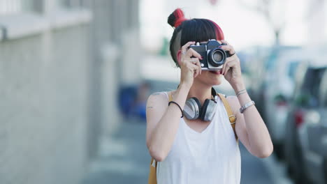 a-young-woman-taking-photographs-with-a-camera