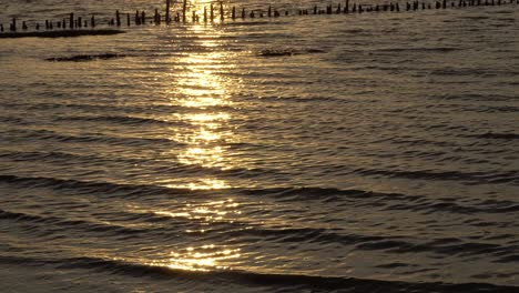 Reflection-of-sun-setting-on-a-rising-tide