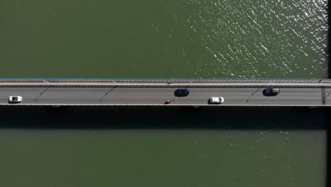 Vertical-aerial-top-view-of-car-bridge-with-traffic-passing-by