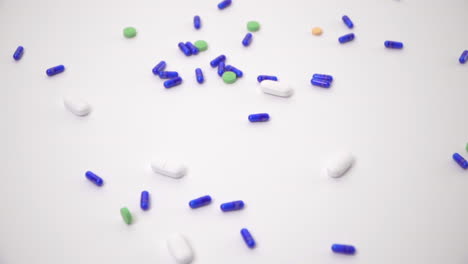 Pill-Varieties-Dropped-onto-White-Background-as-Hand-Reaches-in-to-Pick-Up-Casing