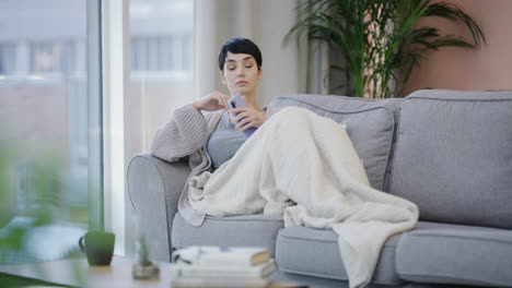 a-young-woman-using-a-smartphone-on-the-sofa