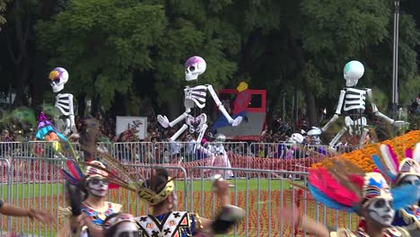 long-shot-on-the-day-of-dead-parade-in-mexico-city,-big-skeletons-dance-on-the-parade