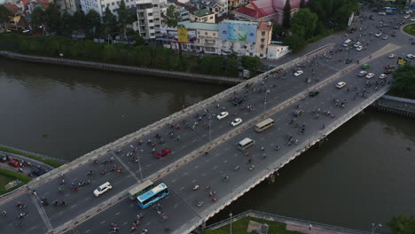 Evening-panning-aerial-view-of-Dien-Bien-Phu-Bridge,-Binh-Thanh-district,-Ho-Chi-Minh-City,-which-crosses-the-Hoang-Sa-canal