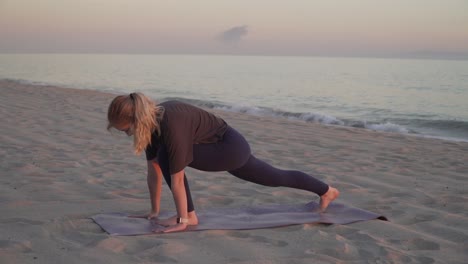 Yoga-teacher-performing-yoga-moves-on-the-beach