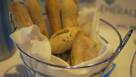 Basket-Of-Bread-Rolls-On-A-Restaurant-Table