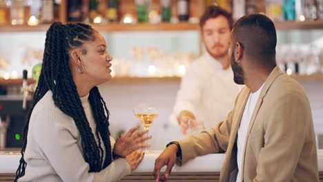 a-young-couple-having-drinks-at-a-bar