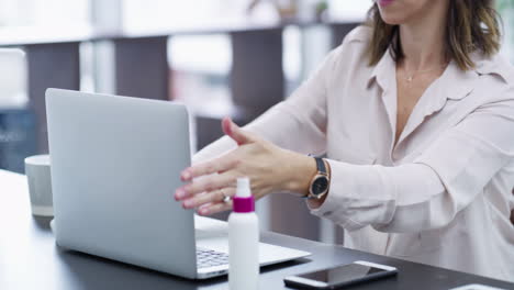 Woman,-cleaning-laptop-and-hands-in-office