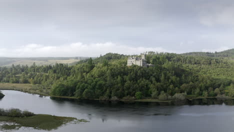 An-aerial-view-of-Carbisdale-Castle-on-a-sunny-morning-with-cloudy-skies