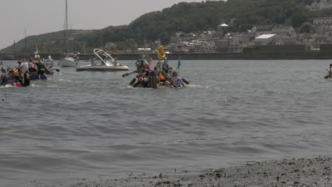 Local-business-teams-race-is-on-at-the-Newlyn-raft-charity-fun-outdoors-event,-Cornwall