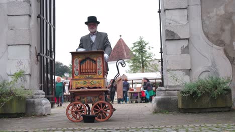 Man-playing-street-organ-at-fair