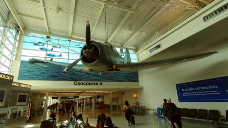Chicago-Midway-airport-decor,-Usa,-United-States,-war-plane-hangs-from-ceiling,-memorial-exhibit,-interior-design