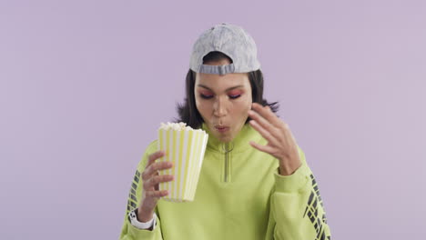 a-beautiful-young-woman-eating-popcorn