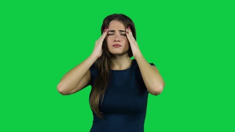 Girl-having-a-headache-in-front-of-a-green-screen