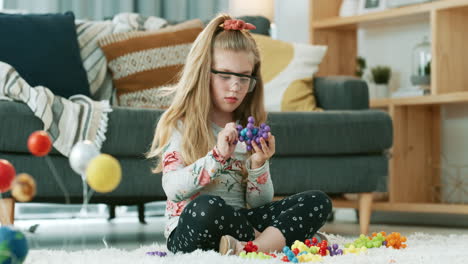 an-adorable-little-girl-playing-with-toy-molecules