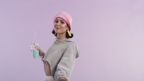 a-young-woman-dancing-while-holding-a-milkshake