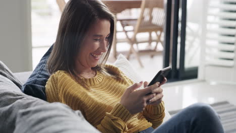 a-young-woman-using-a-smartphone-on-the-sofa