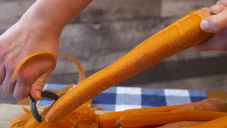 Hand-peeling-a-crispy,-whole-carrot