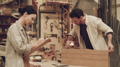 two-young-carpenters-working-together-inside