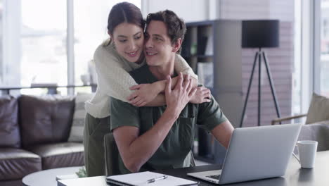 Laptop,-couple-and-love-hug-in-home-with-husband