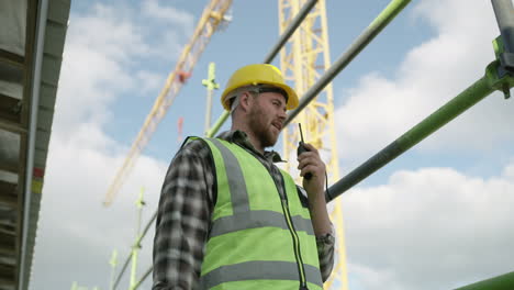 a-young-man-using-a-walkie-talkie-while-working