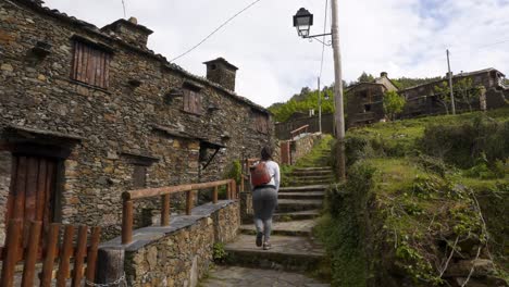 Woman-walking-in-Talasnal-schist-village,-in-Portugal