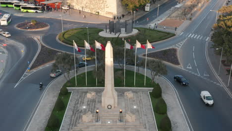 Aerial-Drone-Shot-of-the-National-Flag-and-the-War-Memorial-in-the-Valletta,-the-Capital-City-of-Malta