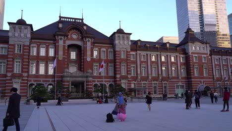 Tourists-Walking-And-Taking-Pictures-In-Front-Of-The-Famous-Tokyo-Station-In-Japan-Before-Sunset---Wide-Shot