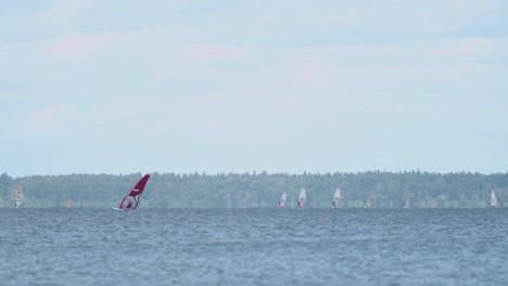 International-wind-surfing-competition-class-formula-foils-in-lake-Burtnieks-moderate-wind-flying-above-water