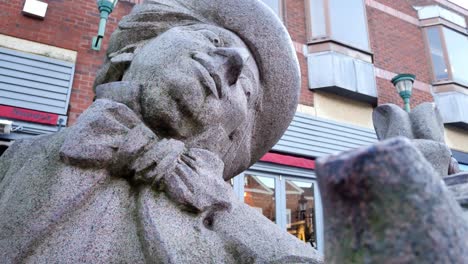 Low-dolly-under-Mad-hatter-tea-party-granite-carved-sculpture-in-Warrington-town-Golden-square