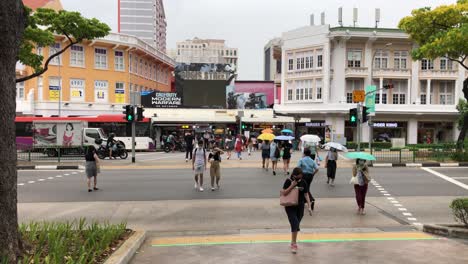 Crowd-crossing-pedestrian-crosswalk,-Bugis,-Singapore.-Slow-motion