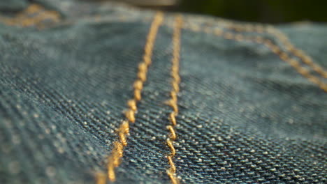 Close-up-rack-focus-on-the-stitching-of-denim-blue-jeans