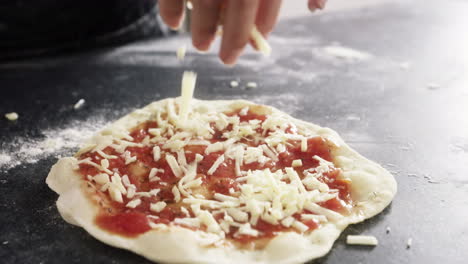 an-unrecognizable-woman-making-a-pizza-at-home