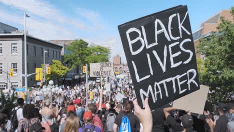 Black-Lives-Matter-sign-held-up-among-a-large-group-of-protesters