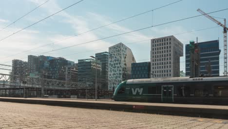 Time-lapse-of-busy-Oslo-city-centre-train-station,-modern-city-life