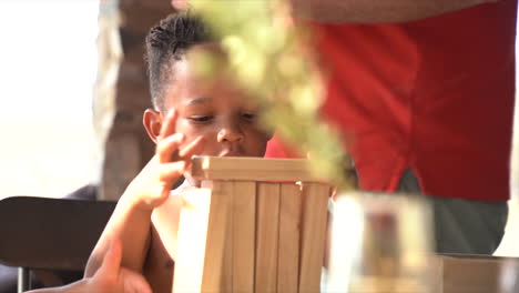 South-African-child-playing-with-building-blocks-then-they-fall-over-all-he-laughs-very-cute