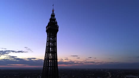 Seaside-landmark-tourist-attraction-Blackpool-tower-nighttime-silhouette-at-sunrise