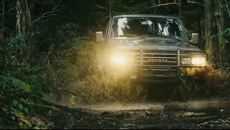 Toyota-Car-with-powerful-momentum-on-bumpy-muddy-trail-in-forest