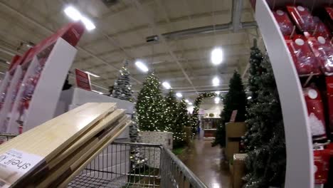 Timelapse-retail-shopping-cart-moving-down-Christmas-aisles-in-shopping-mall-during-covid-pandemic