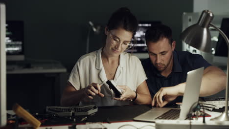 two-young-technicians-repairing-computer-hardware