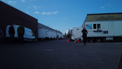 Daytime-time-lapse-of-a-busy-film-production-parking-lot