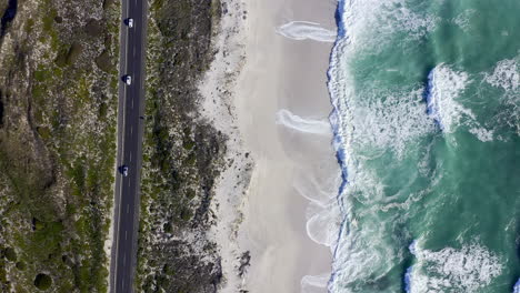 4k-drone-footage-of-cars-driving-on-a-road-along