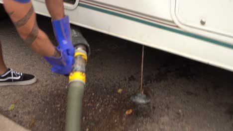 Detaching-the-water-flushign-hose-from-an-RV