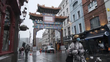 Few-tourists-walking-past-elaborate-London-Chinatown-gate-Covid-Lockdown